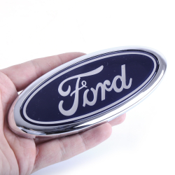 Емблема "FORD" 151х65м (Focus 2 04-11/c-max/kuga/mondeo/connect) Перед (з пружинкою)(Туреччина